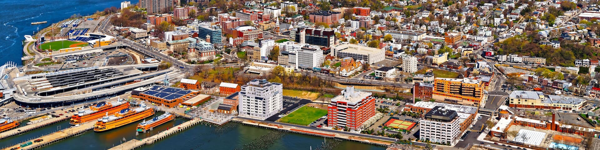 Aerial view of Dry Dock and Repair and Port Newark and Global international shipping containers, Bayonne, New Jersey. NJ, USA. Harbor cargo. Staten Island with St George Ferry terminal, New York City