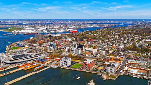 Aerial view of Dry Dock and Repair and Port Newark and Global international shipping containers, Bayonne, New Jersey. NJ, USA. Harbor cargo. Staten Island with St George Ferry terminal, New York City