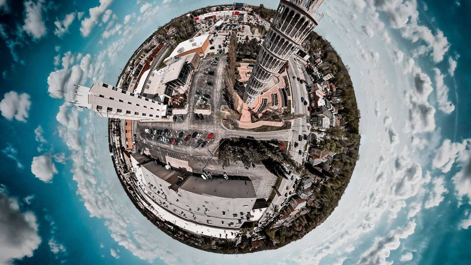 360 of the leaning tower of Niles and a cloudy sky.