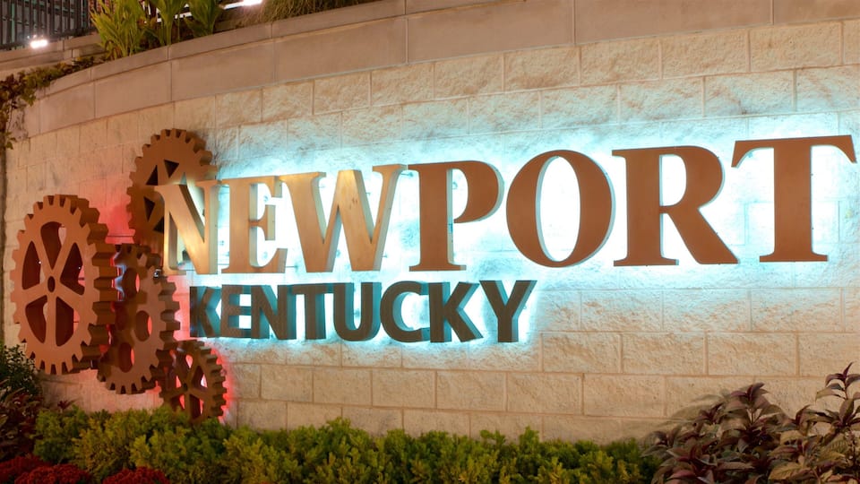A sign with the words "NEWPORT KENTUCKY" and large gears on the left.
