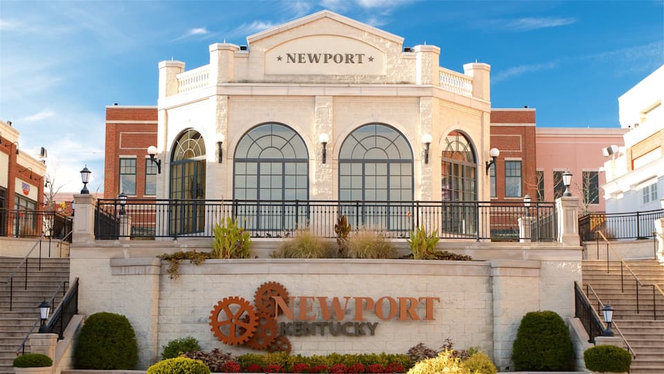 A historic building with arched windows and a sign that reads "Newport Kentucky".