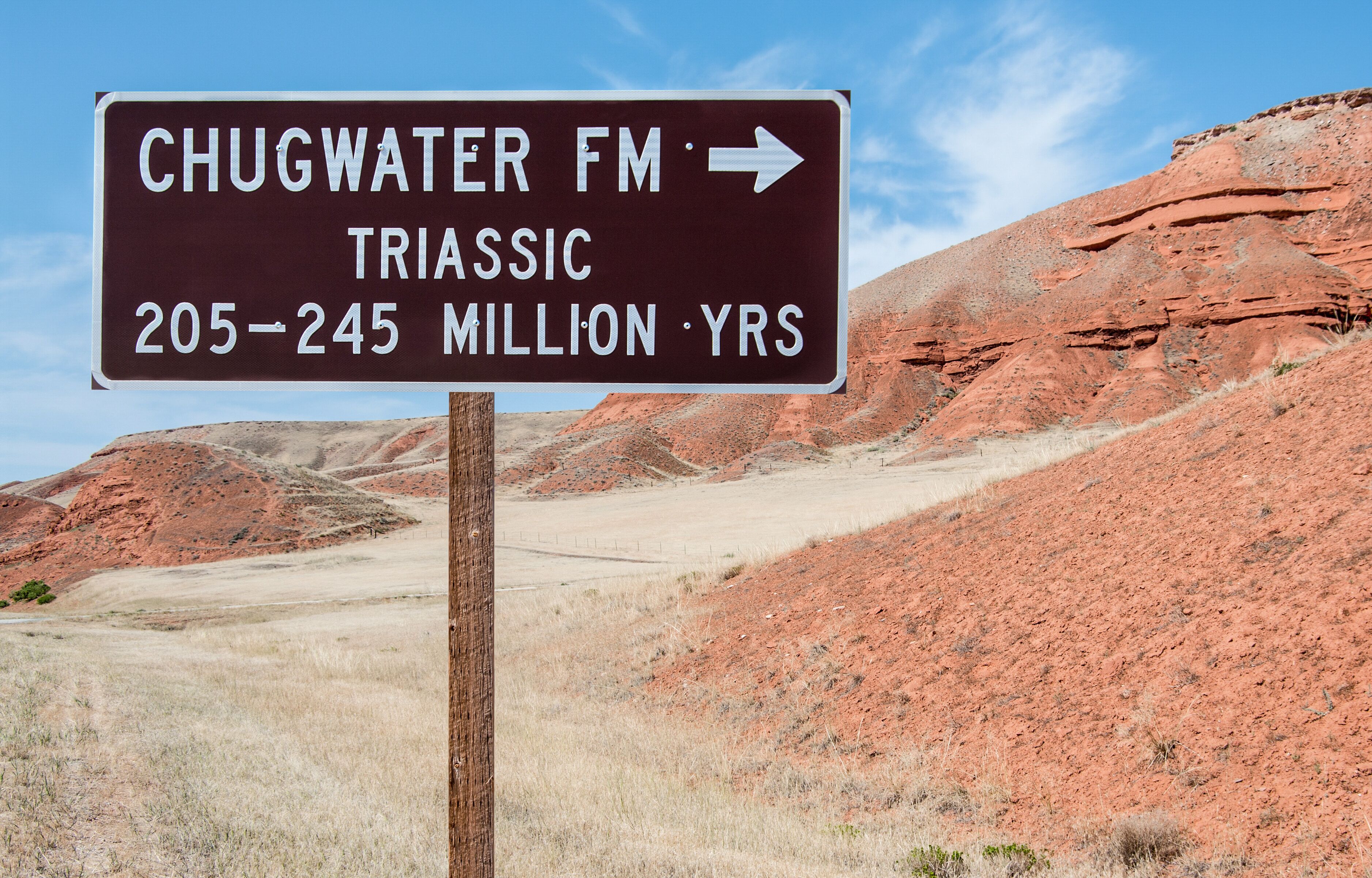 A sign indicating Chugwater FM Triassic 205-245 million years.