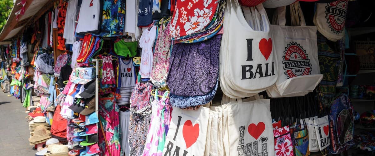 The Kuta Art Market is a good place to do some shopping but be aware... they are pretty aggressive in soliciting your business. It's actually quite obnoxious.  I told one fellow that I might have bought something from him if he had just shut up and let me quietly look at his stuff. 
Haggle... Haggle like a boss. The selling price should be about 30-40 % of the initial asking price. Don't be a sucker Yo !
p.s. don't bring drugs to Bali... they will execute you.
#market