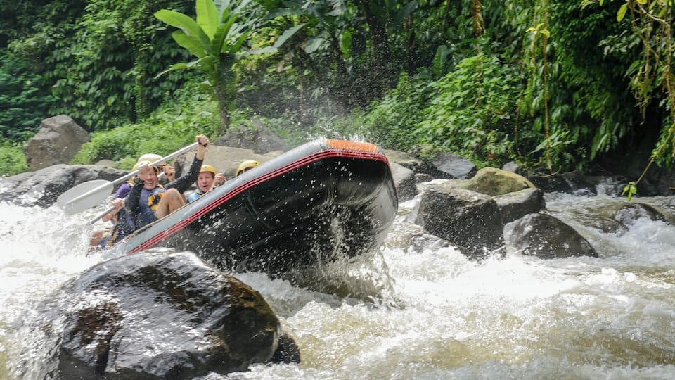 We went White Water Rafting on the Ayung River with Bali Adventure Tours outfitter and they could not have been more accommodating to our group. The experience was truly Epic ! One thing to be aware of is the steep trek down to and up from the river. 200+ stairs... if you have weak knees or you are not in good shape you might want to think about it.
Once on the river you will experience class 2-3 rapids. You are deep in the canyon and will feel very small. Theres a lot of canopy, tons of bamboo, flora and fauna. I did not feel I needed sunscreen as there was mostly shade. The water was cool to cool and a refreshing reprieve from the hot and humid climate.
I would do this one again !