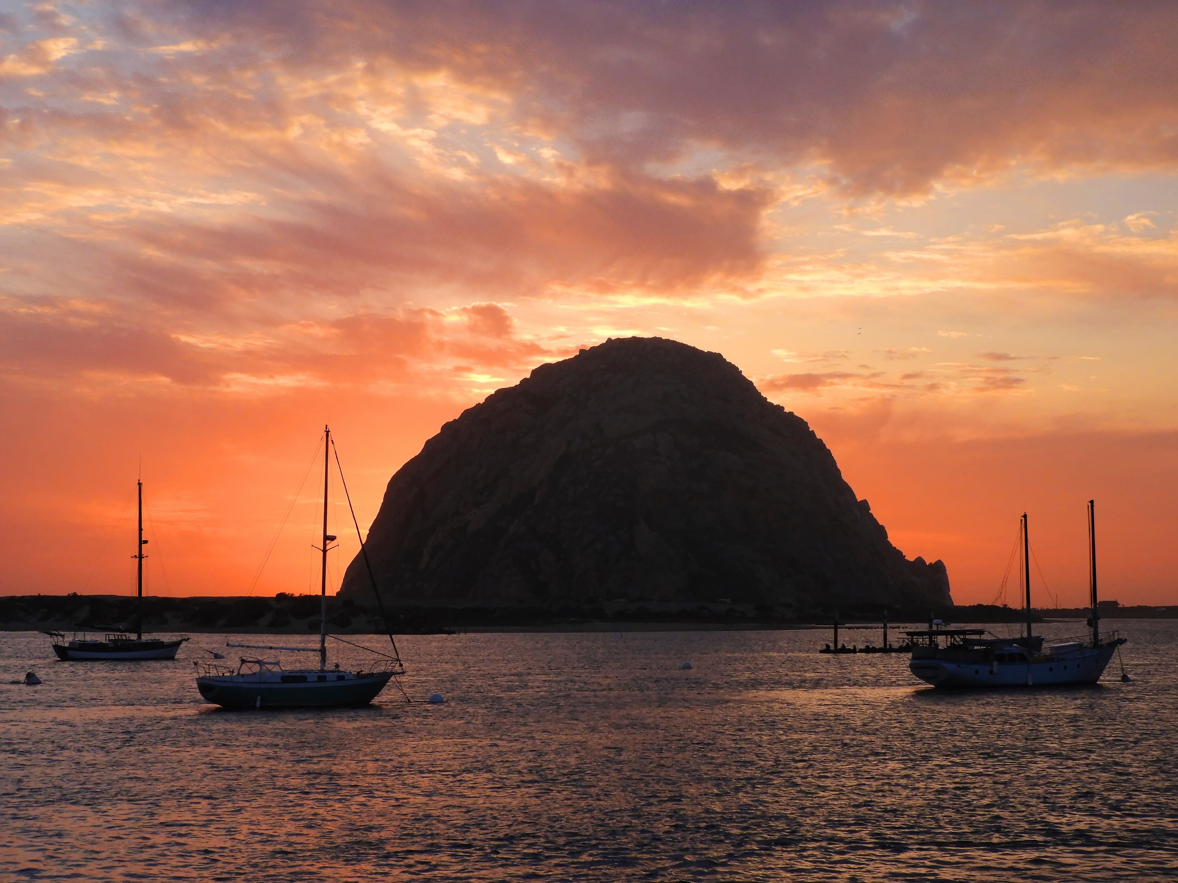 spectacular morro rock and sailboats at sunset in san luis obispo  county on the central california coast 