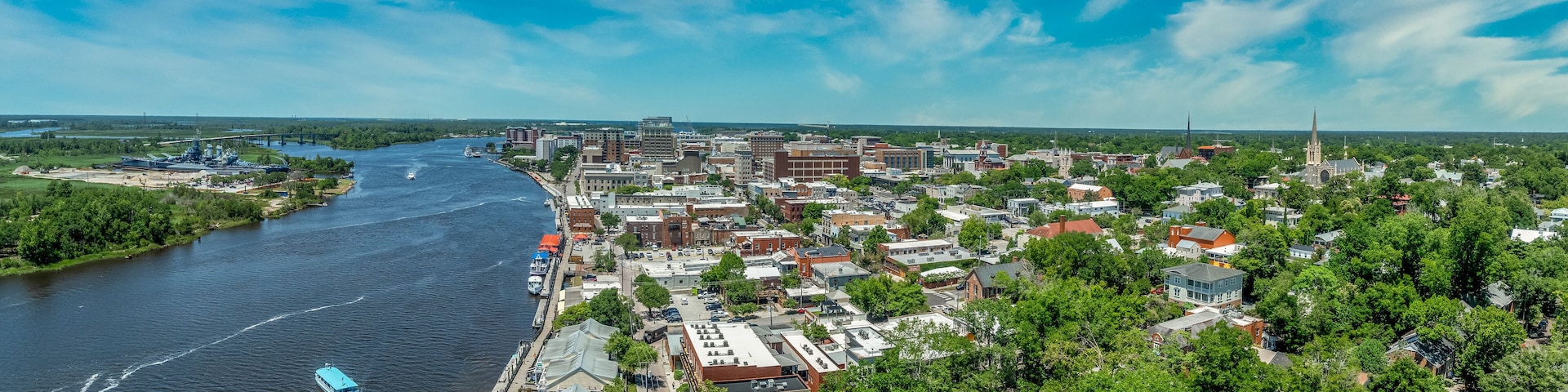Aerial view of Wilmington North Carolina historic district along the Cape Fear river with cloudy sky