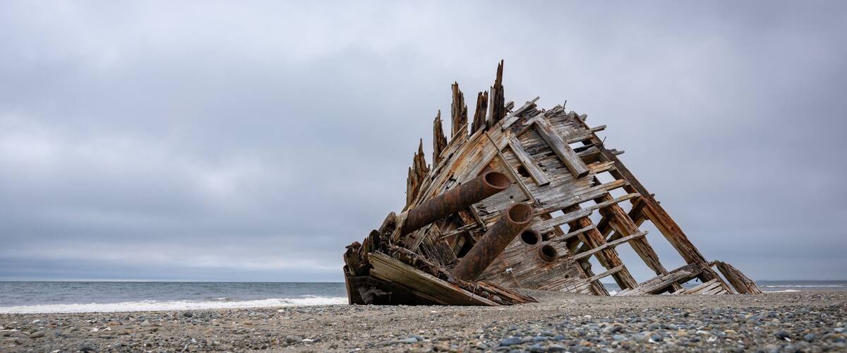 The famous and popular Pesuta Shipwreck on a cloudy day giving it a dark and dramatic effect. The wreck is located on the East Beach in Naikoon Provincial Park, Haida Gwaii British Columbia, Canada