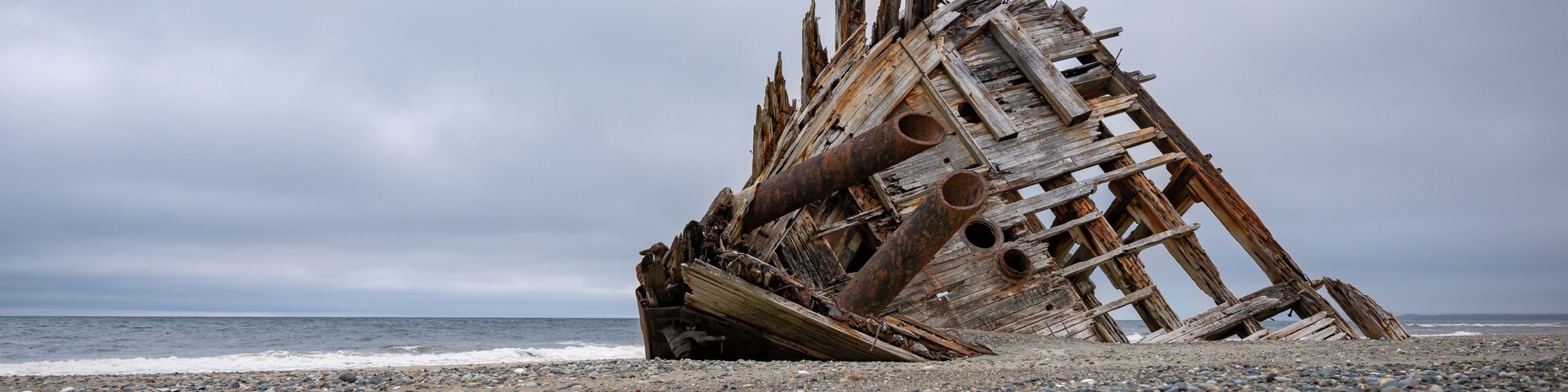 The famous and popular Pesuta Shipwreck on a cloudy day giving it a dark and dramatic effect. The wreck is located on the East Beach in Naikoon Provincial Park, Haida Gwaii British Columbia, Canada