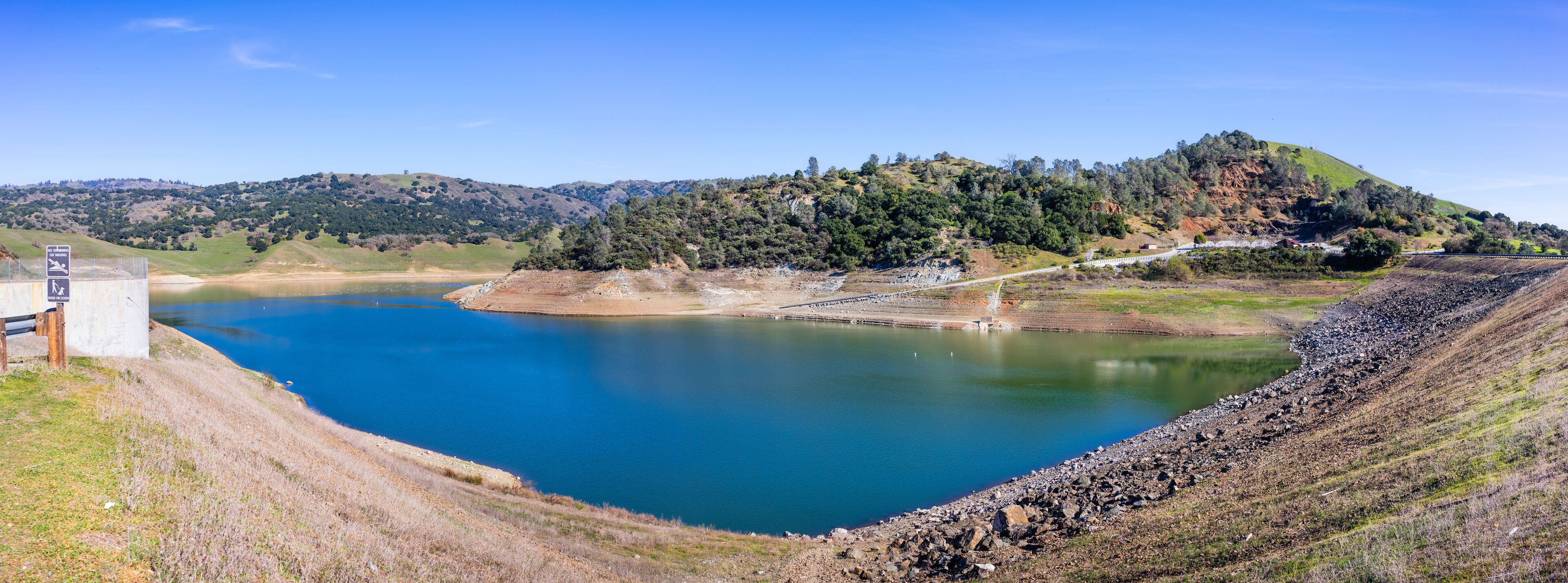 High angle view of Anderson Reservoir, a man made lake in Morgan Hill, managed by the Santa Clara Valley Water District, maintained at low level due to failure risk in case of earthquake; California