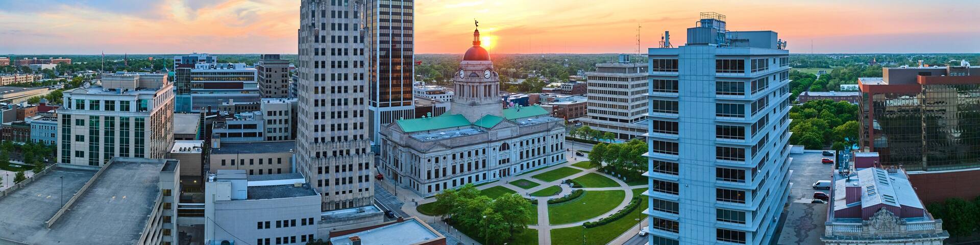 Panorama aerial downtown Fort Wayne golden morning sunrise breaking into brilliant blue skies