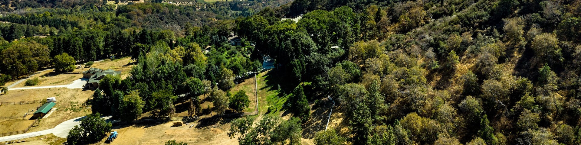 Aerial, drone view of Oak Glen located between the San Bernardino Mountains and Little San Bernardino Mountains with several apple orchards before the Fall color change