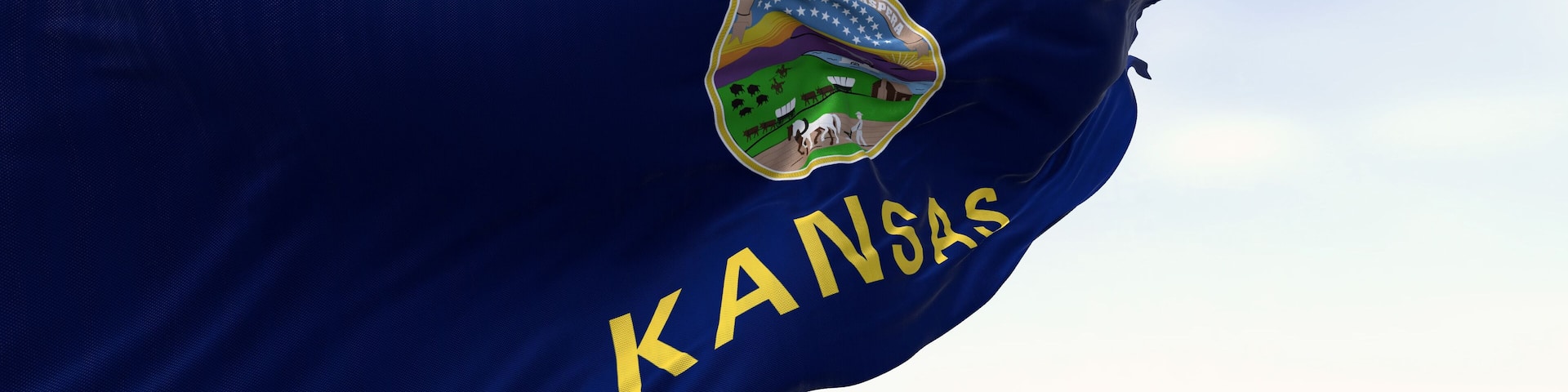 Close-up of Kansas state flag waving in the wind on a clear day