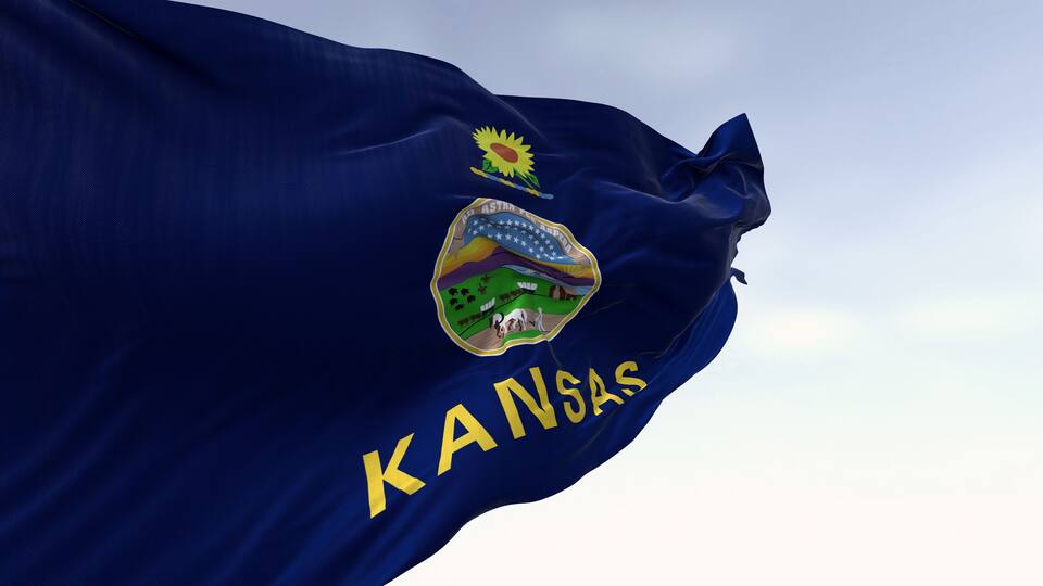 Close-up of Kansas state flag waving in the wind on a clear day