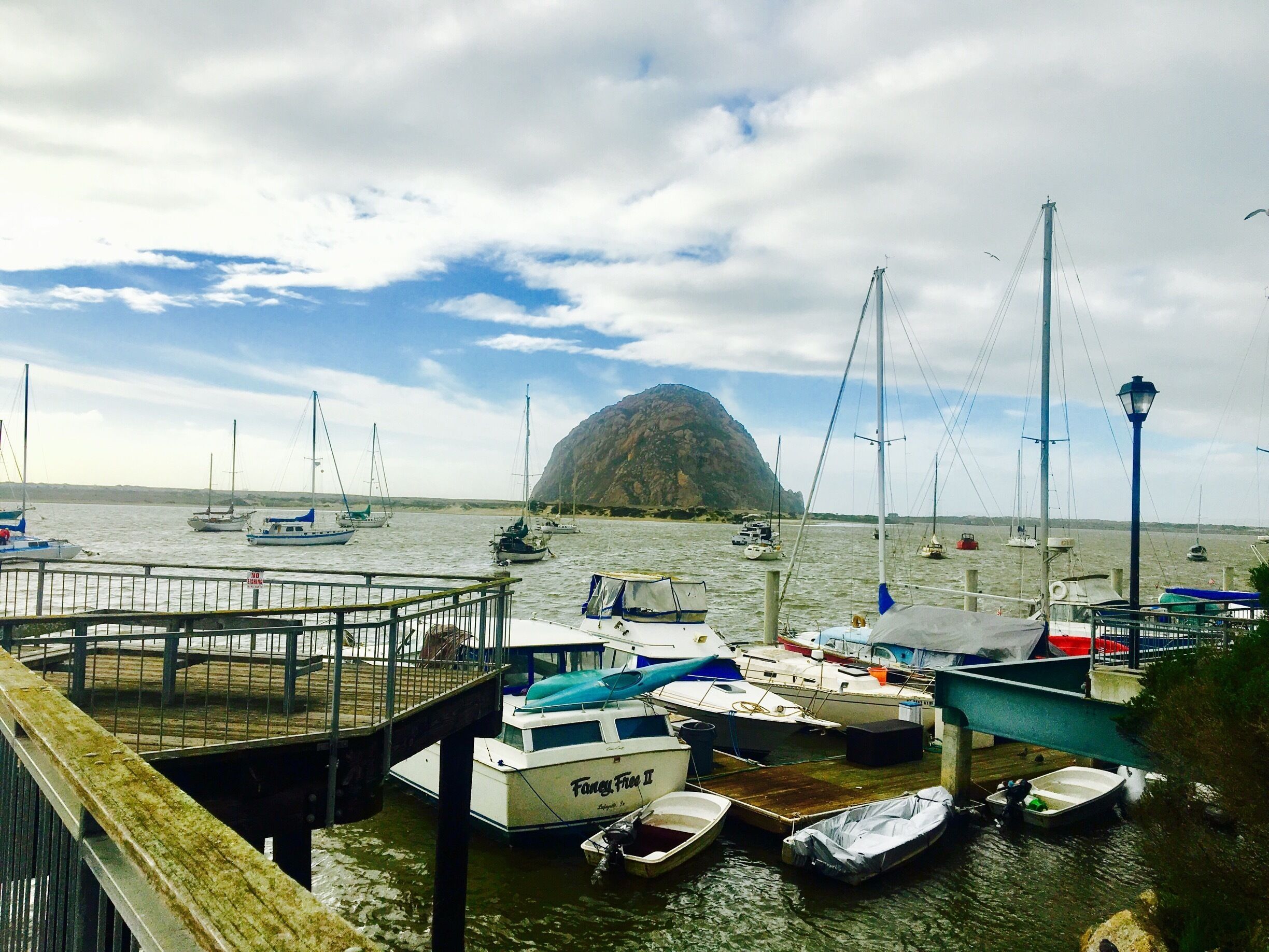Morro Rock is a 581-foot volcanic plug located just offshore from Morro Bay, California, at the entrance to Morro Bay Harbor. A causeway connects it with the shore, effectively making it a tied island.
