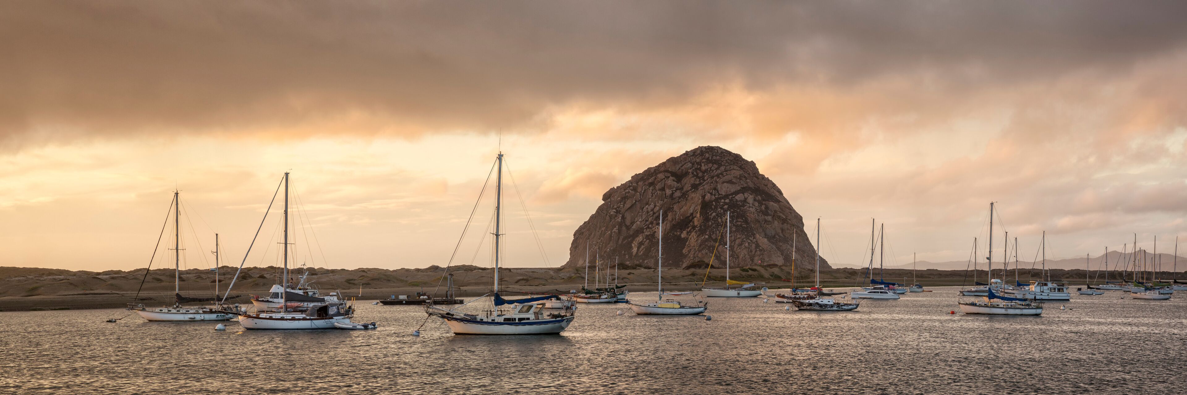 USA, California, Central Coast, Morro Bay. Panoramic view of colorful storm clouds over the harbor