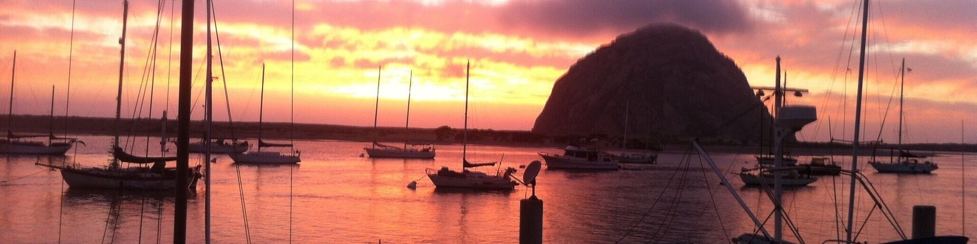 You don't need to look far to find Morro Rock in Morro Bay. It stands up like a beacon on the coast, and once was a notable navigational landmark. Now you can join the thousands of tourists who come here to enjoy the views from all along the coast, or go across the short causeway to get close up.
To get a somewhat decent view of the rock while in town, drive just to the south of the row of shops and restaurants to the small shoreline park. This is also a docking for boats, so it is a pleasant place to stop. Wait till sundown, and you'll see this magnificent view. Morro Bay is adjacent to other places, like Pismo beach and San Luis Obispo. P.s. clam chowders are a must. #GoldenHour #Waterlust #BestOf5