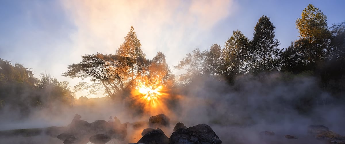 The hot spring with a 73 degree Celsius water spring over rocky terrain. heat from the hot spring providing a misty and picturesque scene which is particular beautiful in the morning.