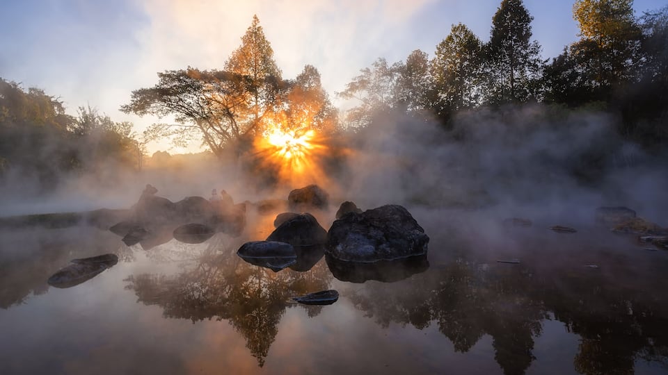 The hot spring with a 73 degree Celsius water spring over rocky terrain. heat from the hot spring providing a misty and picturesque scene which is particular beautiful in the morning.