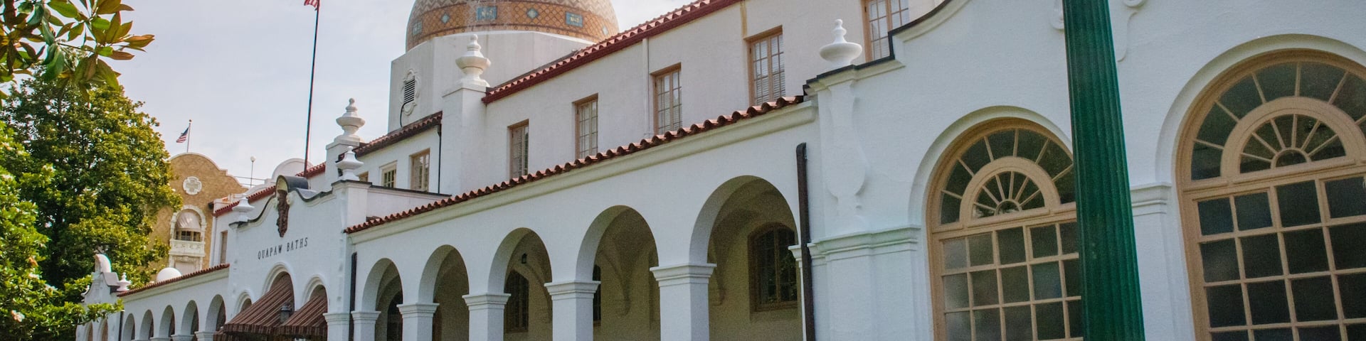 A white building with a dome and arched windows.