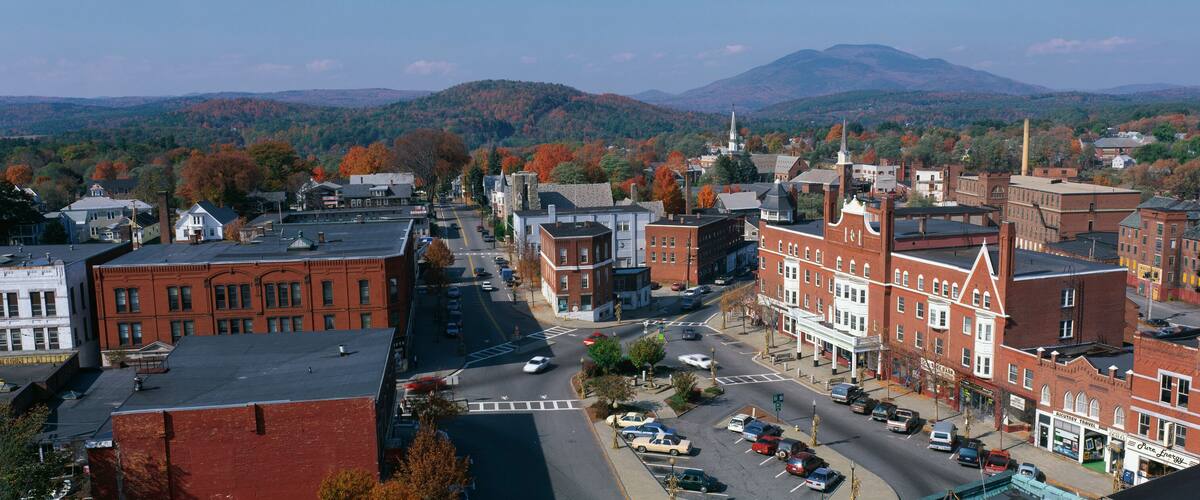 This is a panorama view from the Bell Tower in Claremont. It shows a typical scene from small town America. The buildings are mostly made from red brick. We see fall foliage in the background.