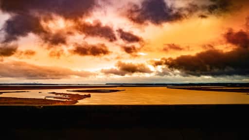 Dramatic winter weather conditions and cloudscape at sunrise over the Pascagoula River near Creole Bayou, Mississippi, USA, saturated road trip snapshot