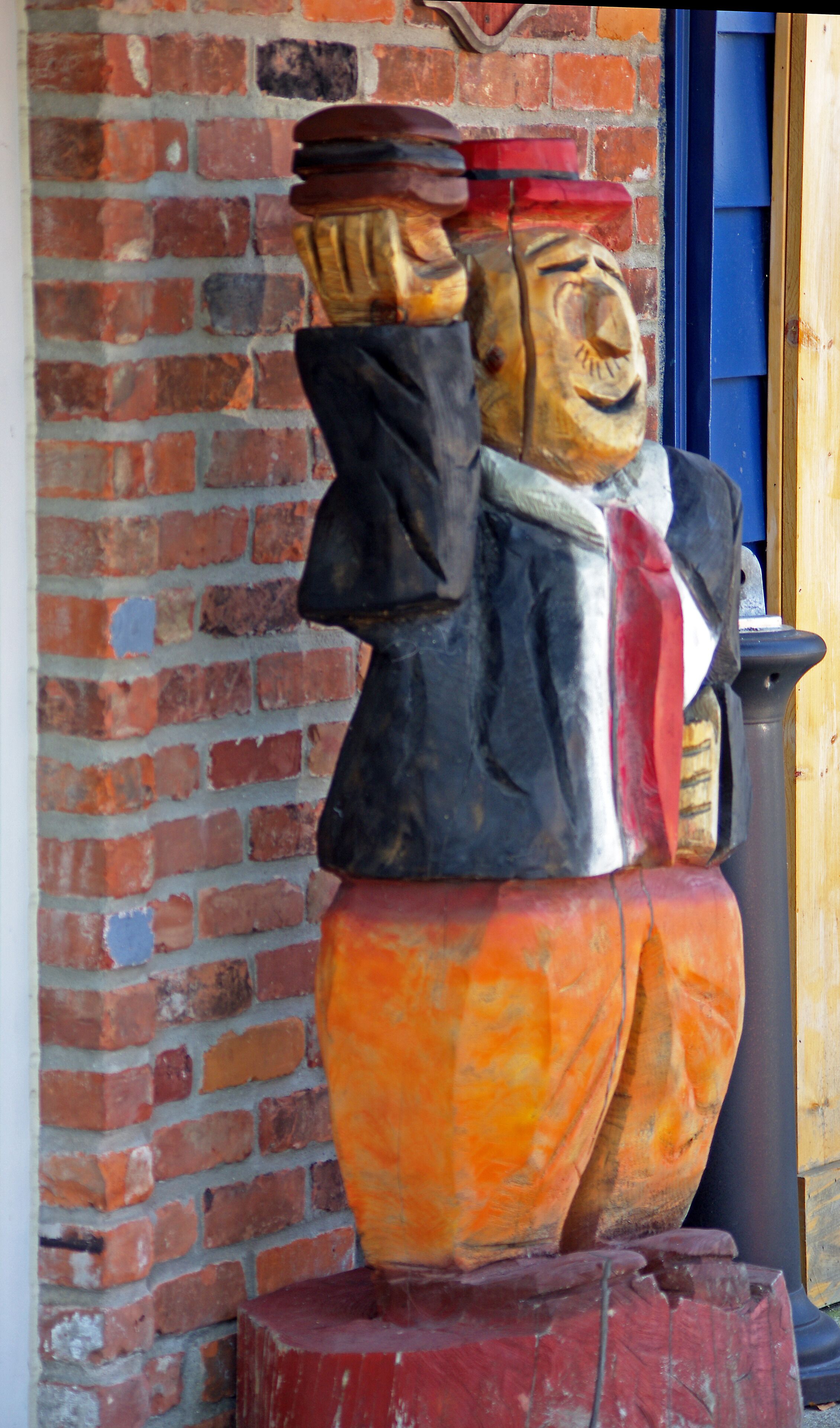 This is a carving of J. Wellington Wimpy, generally known as "Wimpy" is a character in the old Popeye comic strip who is  famous for the line "I'll gladly pay you Tuesday for a hamburger today".