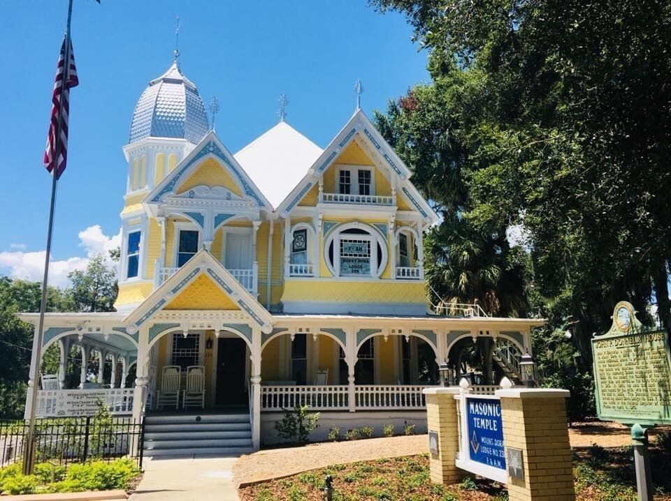 AKA The Donnelly House

John P. Donnelly came to Mount Dora in 1879 from Pittsburgh, PA. He married Annie McDonald Stone in 1881 and built this Queen Anne style house in 1893 as a gift to her. He was among the founders of the local yacht club, and served as the city´s first mayor in 1910. The Donnelly House, now owned by Mount Dora Lodge #238, F&AM, was listed in the National Register of Historic Places on April 4, 1975.

Mount Dora is a cute town on the banks of Lake Dora surrounded by antiquing opportunities and is just a short drive to the massive Renningers Antique Market