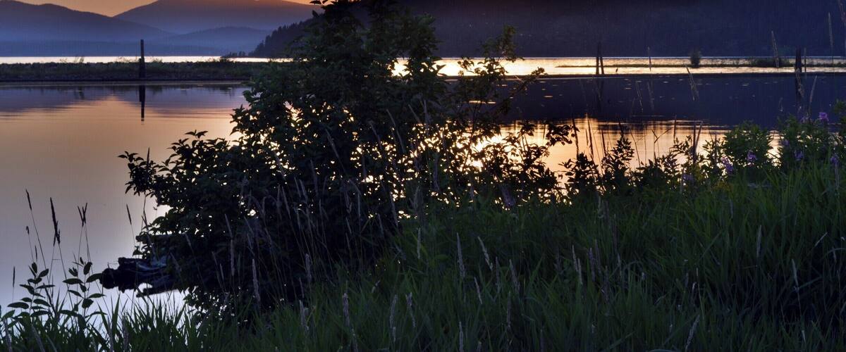 The sun is just setting on the driftyard at the edge of Lake Pend Oreille. They try to catch floating logs before they enter the lake so this is off the Clark Fork River delta. Photo by Shylah Perkins