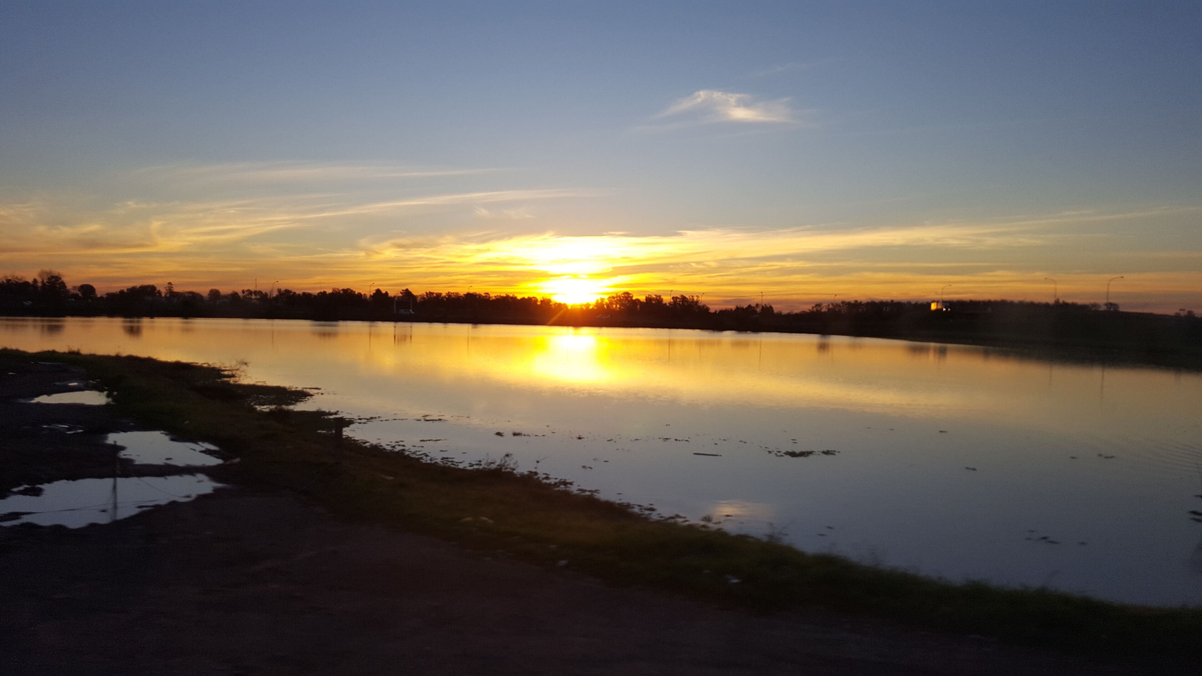 Sunset over a lake on the road from Cordoba to foz de iguacu