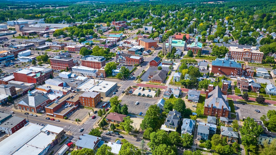 City with houses and industrial buildings and churches aerial