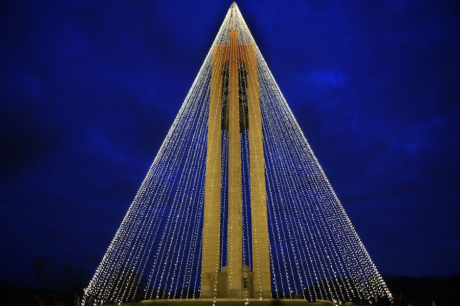 Una gran estructura piramidal iluminada durante la noche.