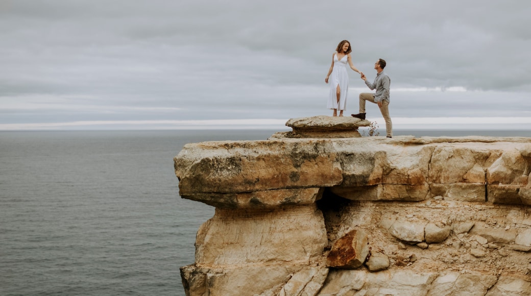 Man proposes marriage to woman on cliff, Pictured Rocks, Michigan