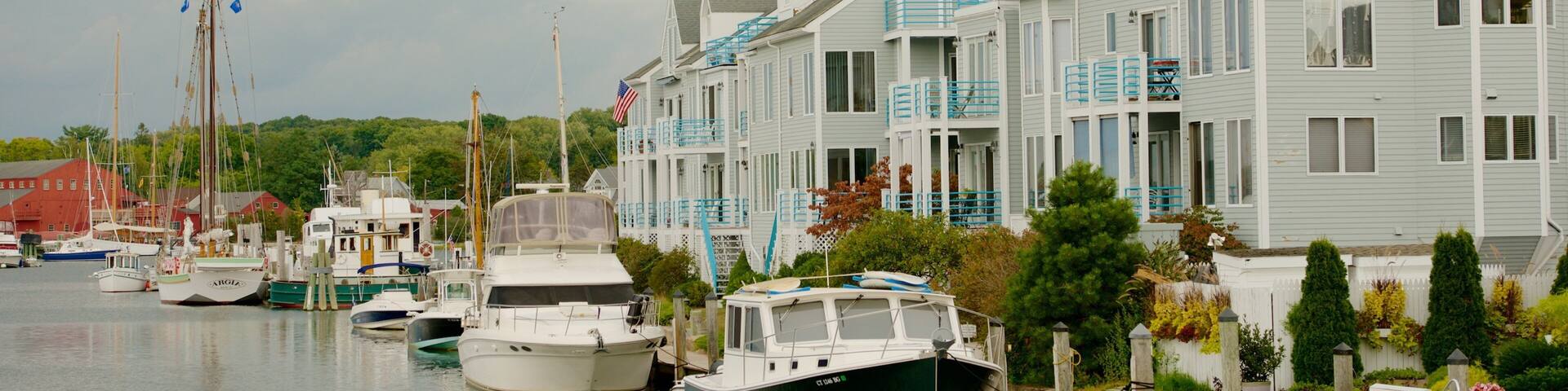 Mystic which includes a house and a bay or harbor