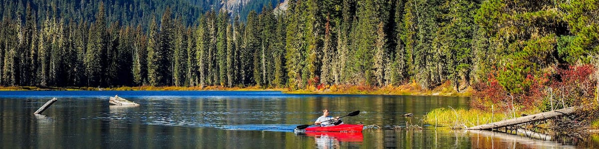 USA, Washington State, Cle Elum, Kittitas County. Red canoe on Cooper Lake.