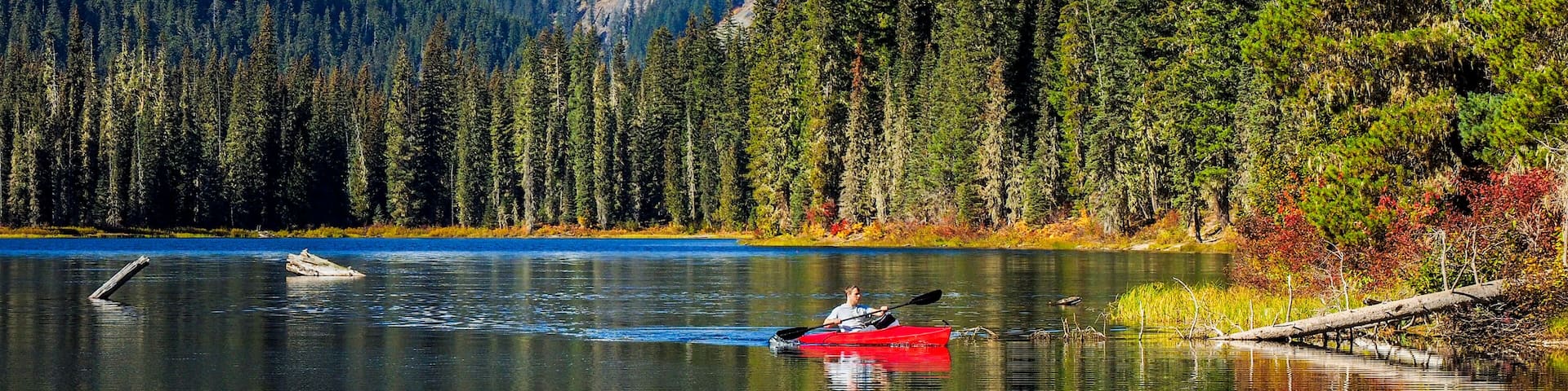 USA, Washington State, Cle Elum, Kittitas County. Red canoe on Cooper Lake.