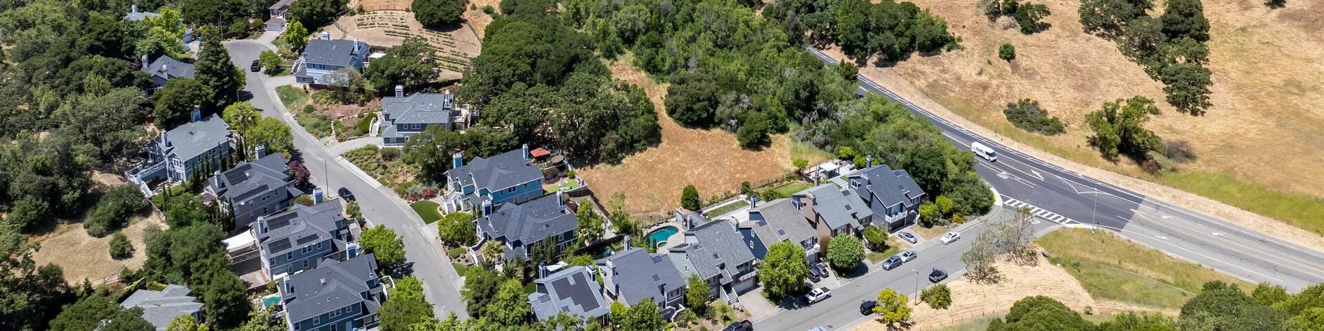 Aerial views of the San Marin neighborhood and surrounding hills in Marin County, California. Suburban homes, winding roads, and oak-dotted golden hills define the scenic North Bay landscape.