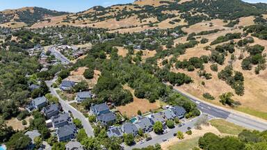 Aerial views of the San Marin neighborhood and surrounding hills in Marin County, California. Suburban homes, winding roads, and oak-dotted golden hills define the scenic North Bay landscape.