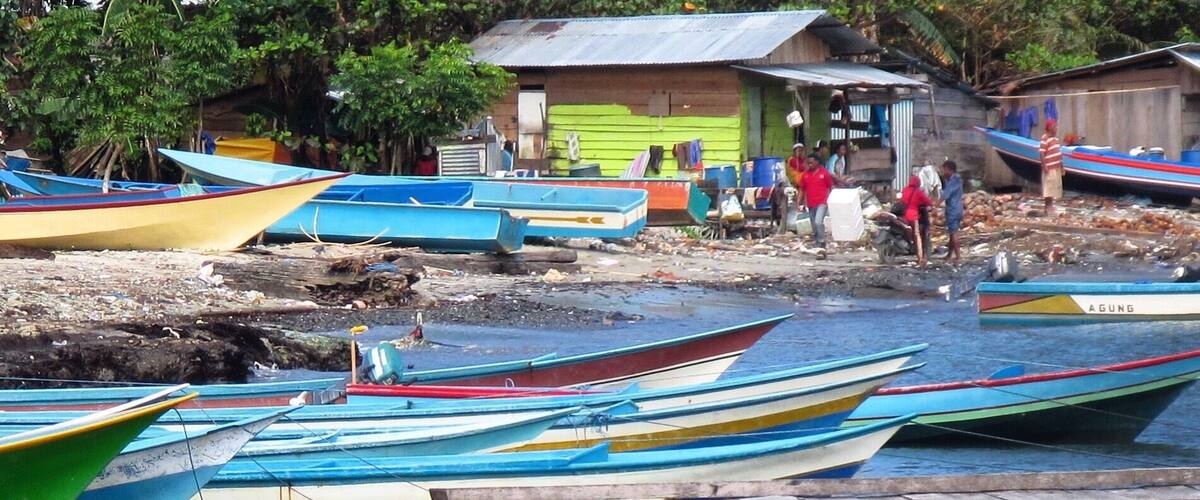 A dock with colorful boats.