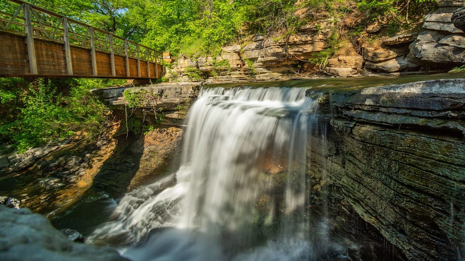 Waterfall Cascading Under Rustic Wooden Bridge in the Ozarks.