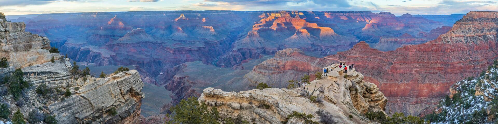 People admire the incredible sunset views of Grand Canyon National Park, Northern Arizona, USA.