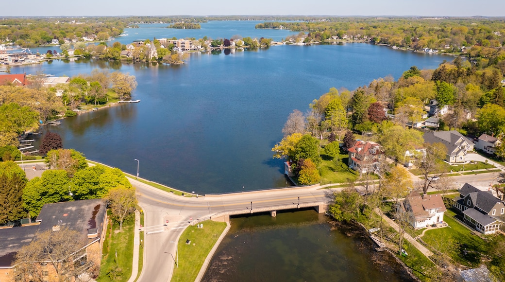 Aerial view of Oconomowoc Lake and surrounding residential and commercial buildings