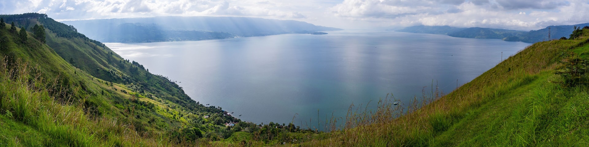 Panoramic view of Lake Toba from Smiling Hill or Bukit Senyum in Bahasa. North Sumatra - Indonesia as one of the biggest volcanic lake