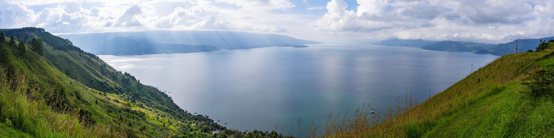 Panoramic view of Lake Toba from Smiling Hill or Bukit Senyum in Bahasa. North Sumatra - Indonesia as one of the biggest volcanic lake