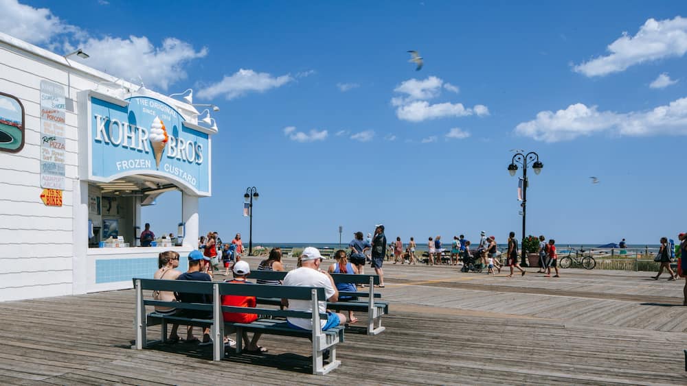 Ocean City showing signage and a coastal town as well as a family