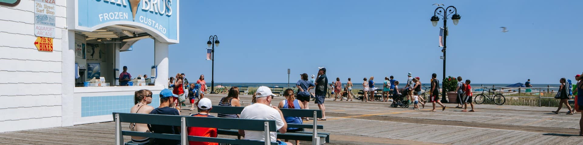 Ocean City showing signage and a coastal town as well as a family