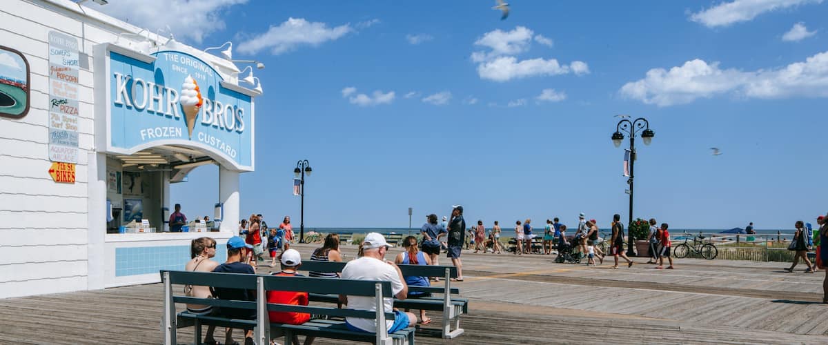 Ocean City showing signage and a coastal town as well as a family