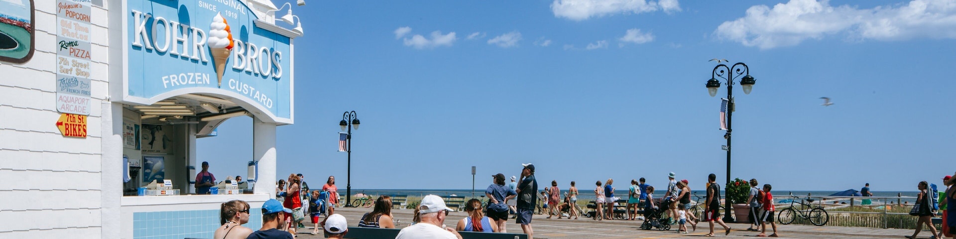 Ocean City showing signage and a coastal town as well as a family