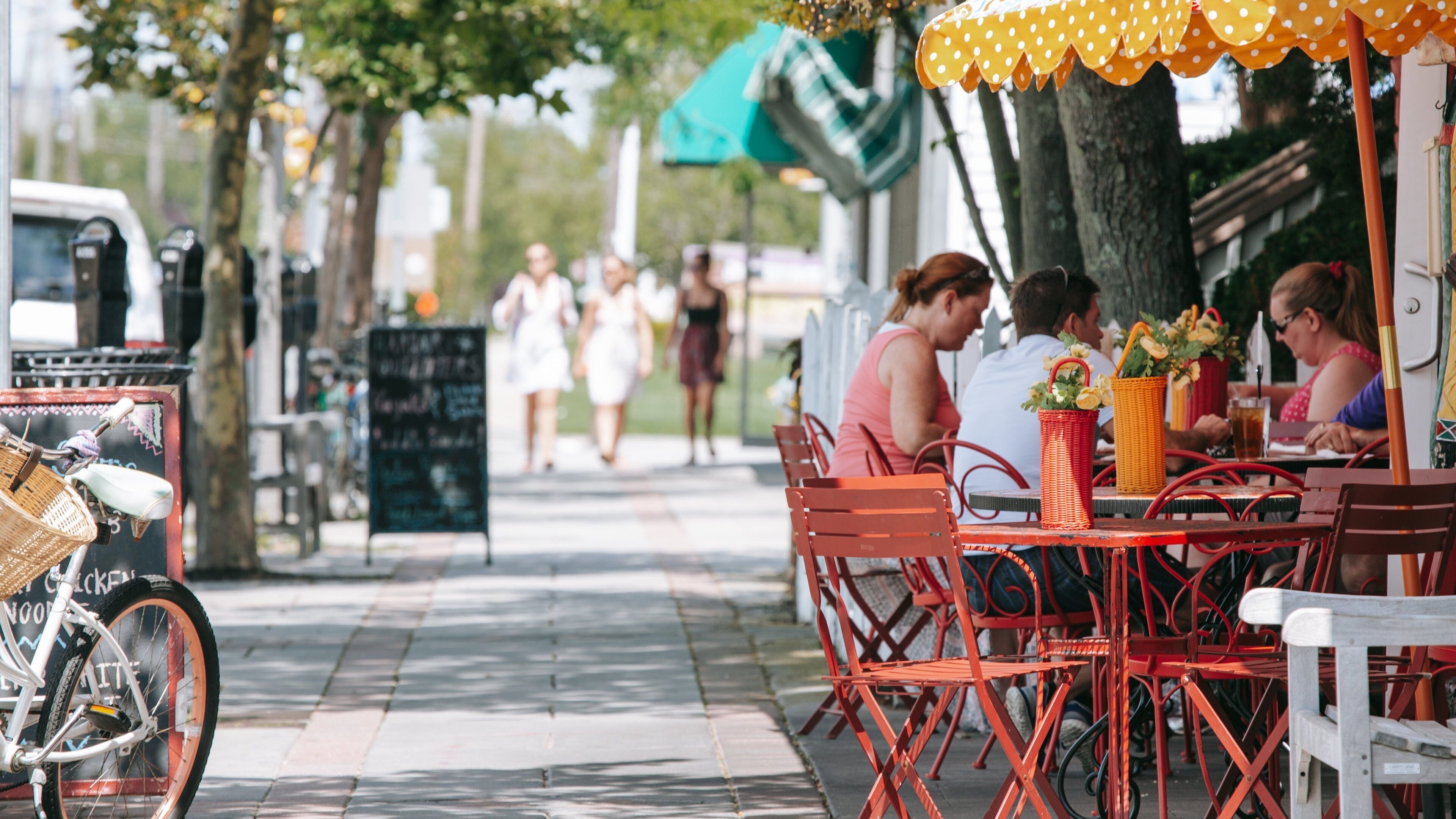 Ocean City featuring outdoor eating as well as a small group of people