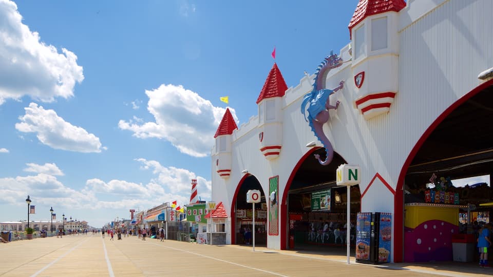 A boardwalk with shops and a castle-like building with a seahorse statue.