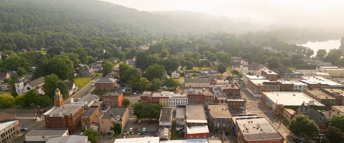 A town with a river, surrounded by hills.